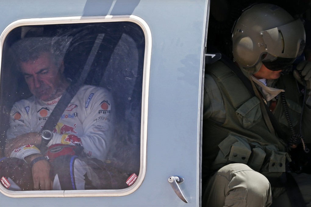 Carlos Sainz of Spain is evacuated by helicopter after the crash that ended his challenge. Photo: Reuters