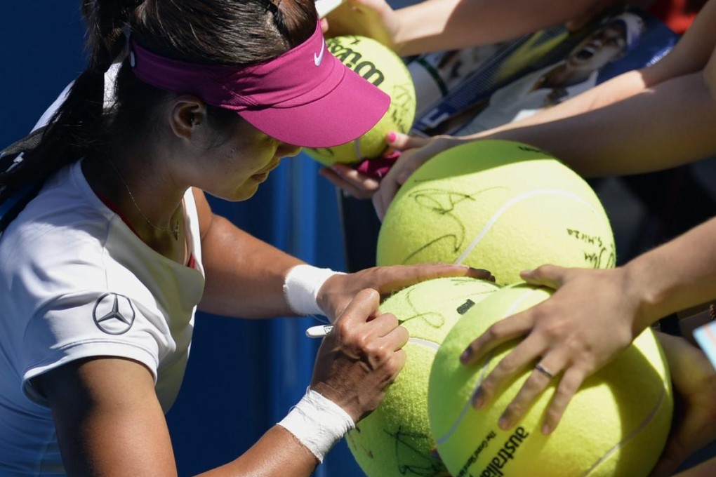 Li Na signs autographs for fans after battling to a three-set win over Lucie Safarova of the Czech Republic at the Australian Open. Photo: EPA