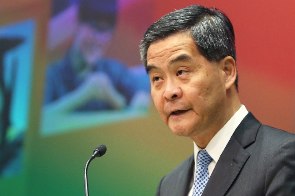 Chief executive Leung Chun-ying poses for the photographers with hard copies of Policy Address 2014 in a press conference. Photo: K. Y. Cheng