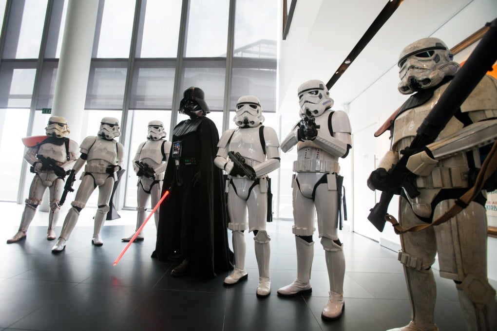 Actors dressed as Star Wars characters pose for the media during the opening ceremony for Lucasfilm Ltd.'s Sandcrawler building. Photo: Bloomberg