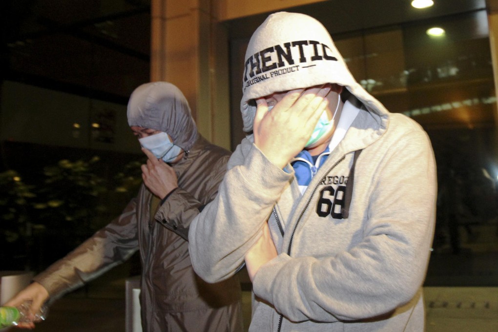 Two unidentified members of Happy Valley leave ICAC headquarters after facing questions over match-fixing. Photo: Nora Tam