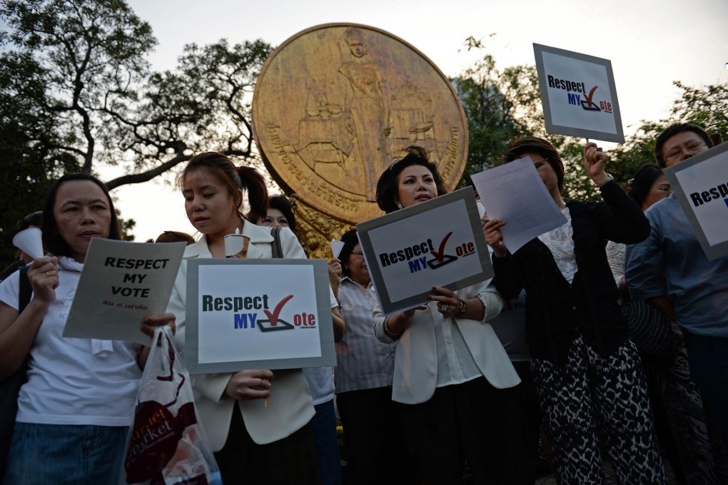 Pro-election activists stage a candlelight vigil in Bangkok. Photo: AFP