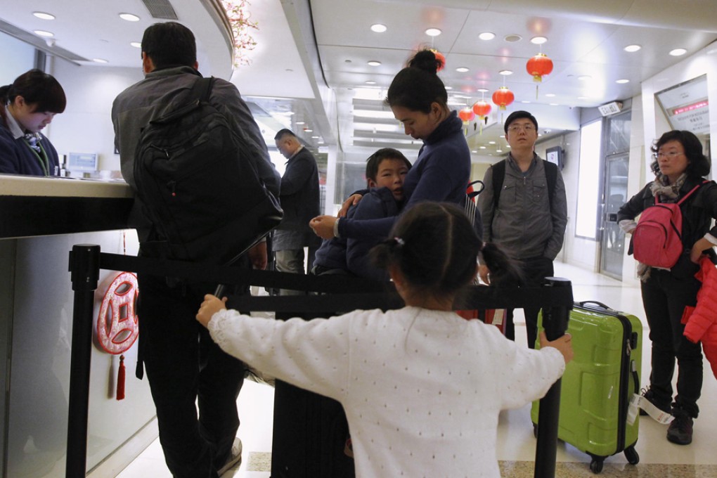 Visitors check in at the Holiday Inn Express in Causeway Bay. The city could receive 70 million tourists annually by 2017. Photo: Edward Wong