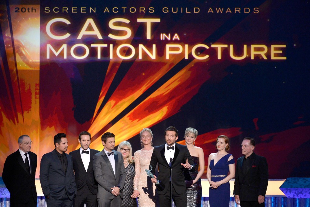 Actor Bradley Cooper accepts the award for Outstanding Performance by a Cast in a Motion Picture for "American Hustle" Screen Actors Guild Awards in Los Angeles. Photo: AFP