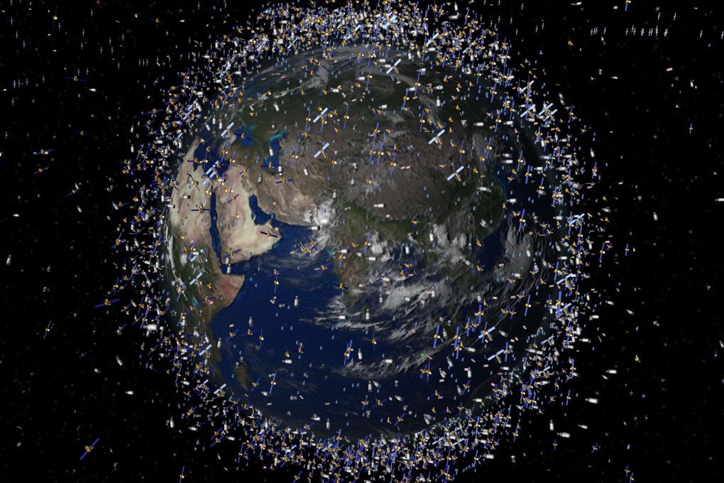 A computer-generated image of satellites orbiting earth. More than 20,000 pieces of space junk are in orbit around the planet. Photo: AP