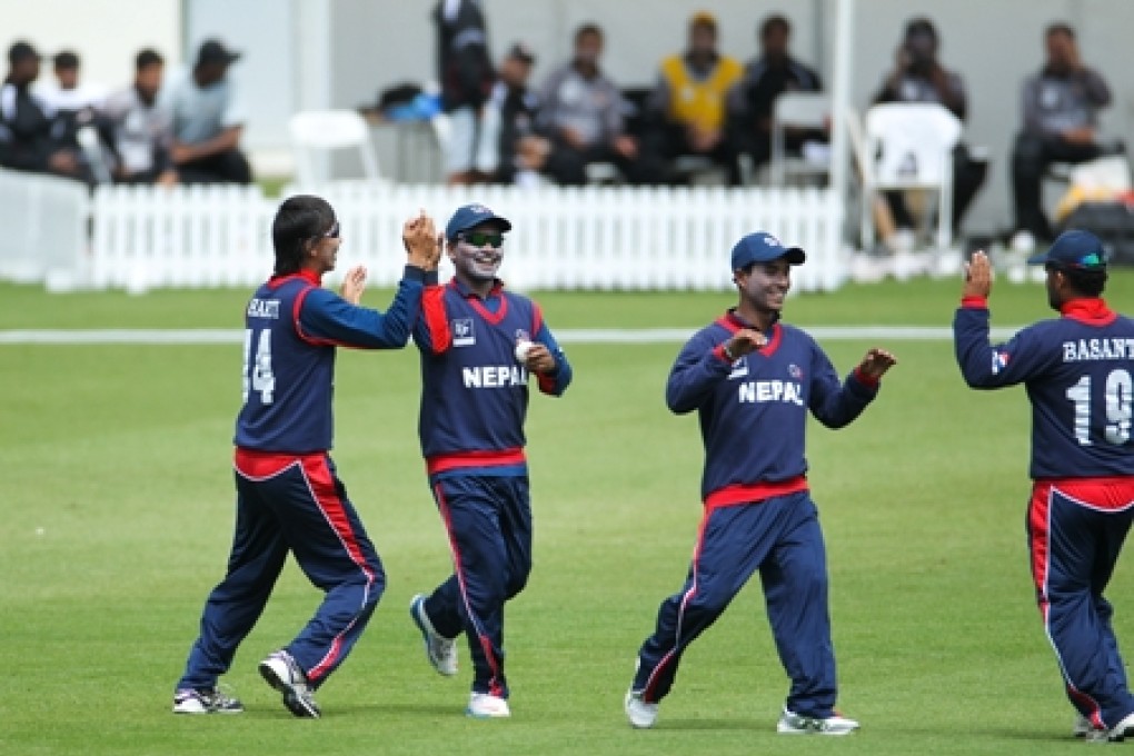 Nepal's teammates celebrate taking a wicket in an earlier match in New Zealand. Hong Kong will have to be wary of their rivals in one of two final games. Photo: 2014 © IDI/Getty Images