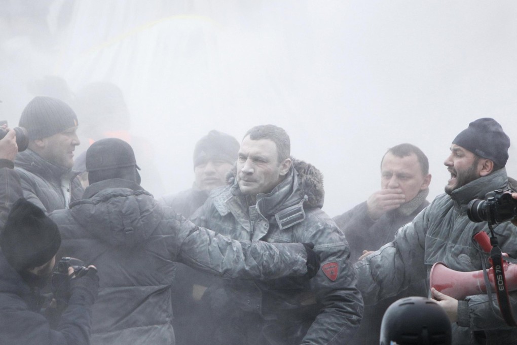 Opposition leader Vitaly Klitschko, centre, is sprayed with a powder fire extinguisher during pro-European protests. Photo: Reuters