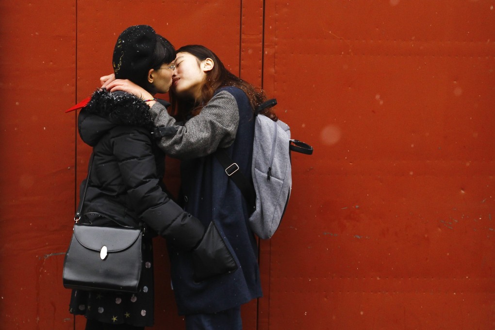 A couple kiss outside a marriage registry office in Beijing where their marriage application was denied. Photo: EPA