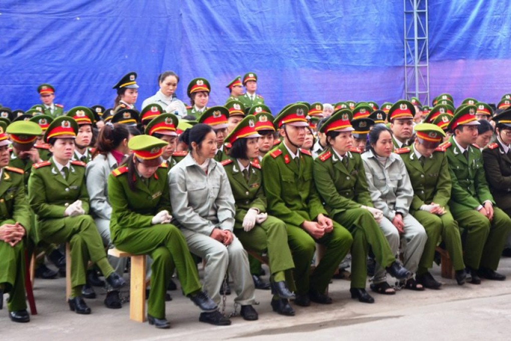 Drug traffickers sit during their trail in Quang Ninh, Vietnam. Photo: EPA