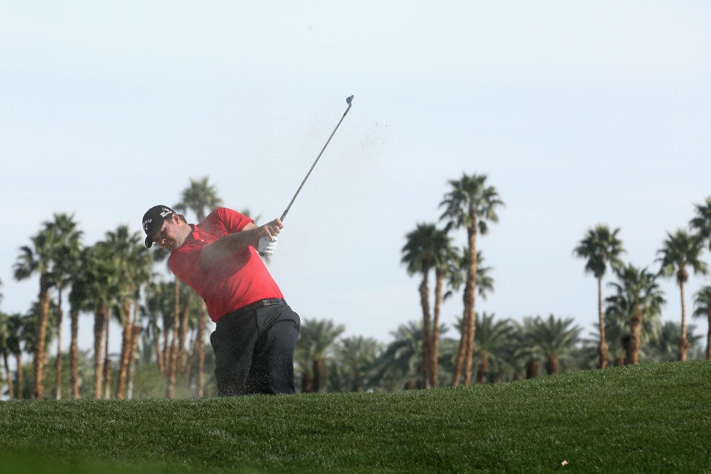 Patrick Reed hits out of a fairway bunker on the 10th hole during the final round of the Humana Challenge. Photo: AFP