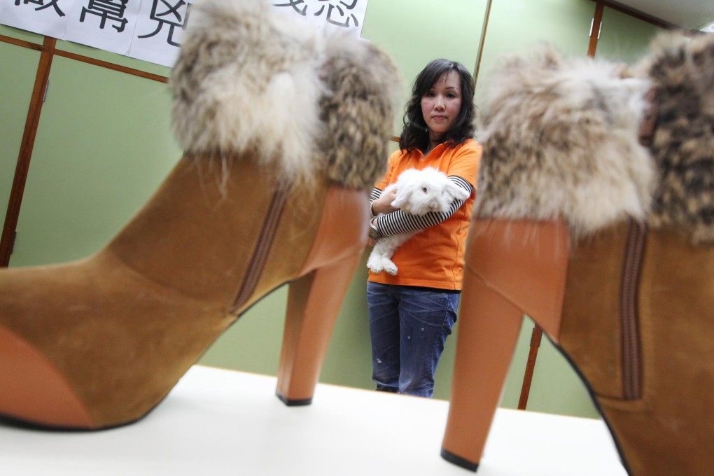 Rabbit Society's Joanna Chow, seen here with her lop-eared rabbit at a press conference, urges consumers to avoid buying products that use fur. Photo: Nora Tam