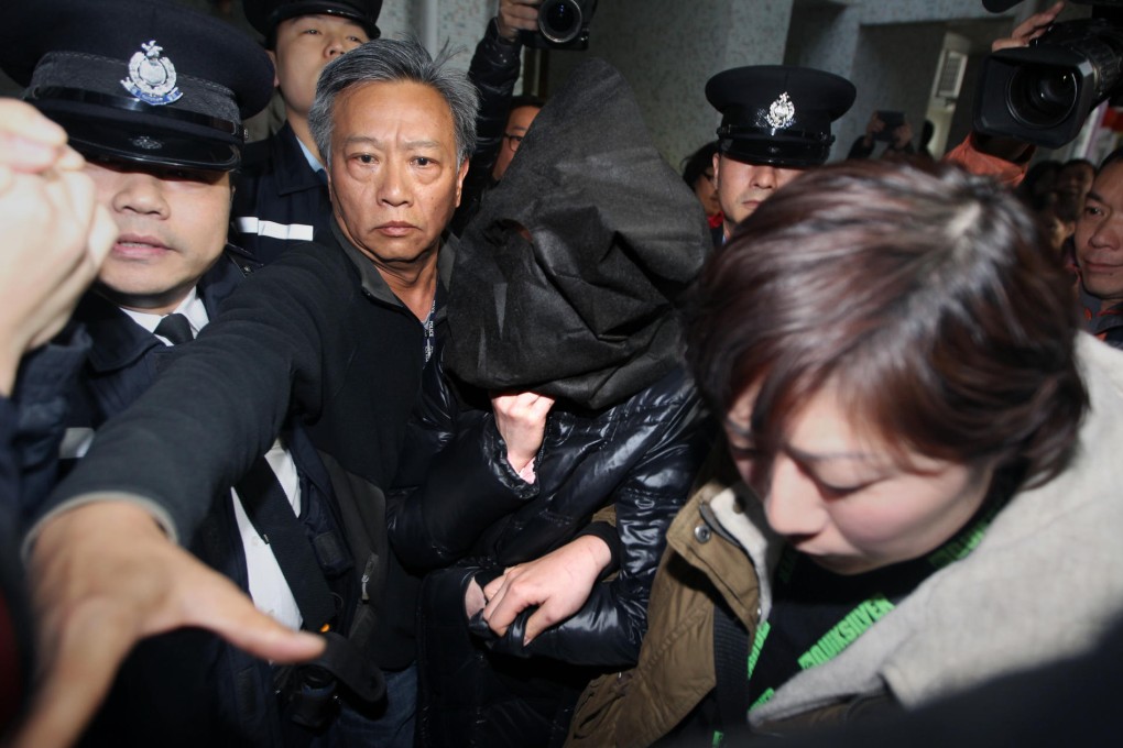 Suspect Lo Wan-tun is taken back to her Tseung Kwan O flat in a mask yesterday. Photo: Felix Wong