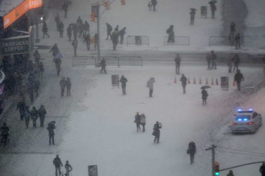 People trudge through snow in New York's Times Square on Tuesday after a blizzard. Photo: AFP