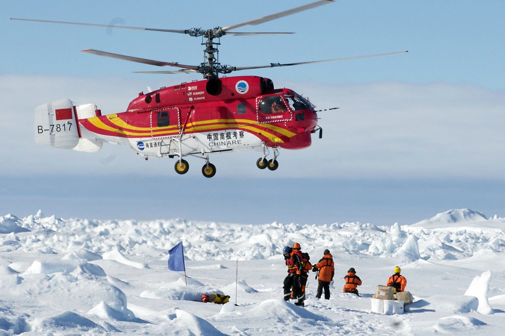 A helicopter from the Chinese ship, Xue Long, transferred trapped scientists to the Aurora Australis, which docked in Hobart. Photo: AFP