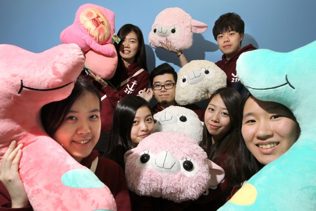 City University students with cushions in the shape of the grass mud horse's head. Photo: Sam Tsang