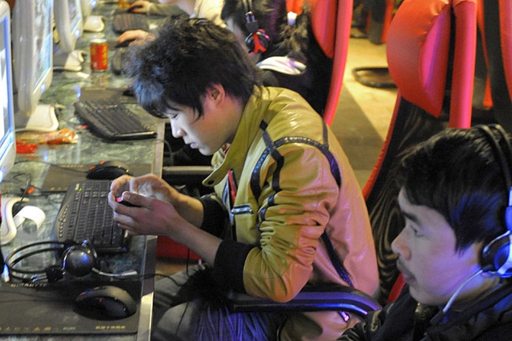 Young men at an internet cafe in Beijing. Photo: AFP