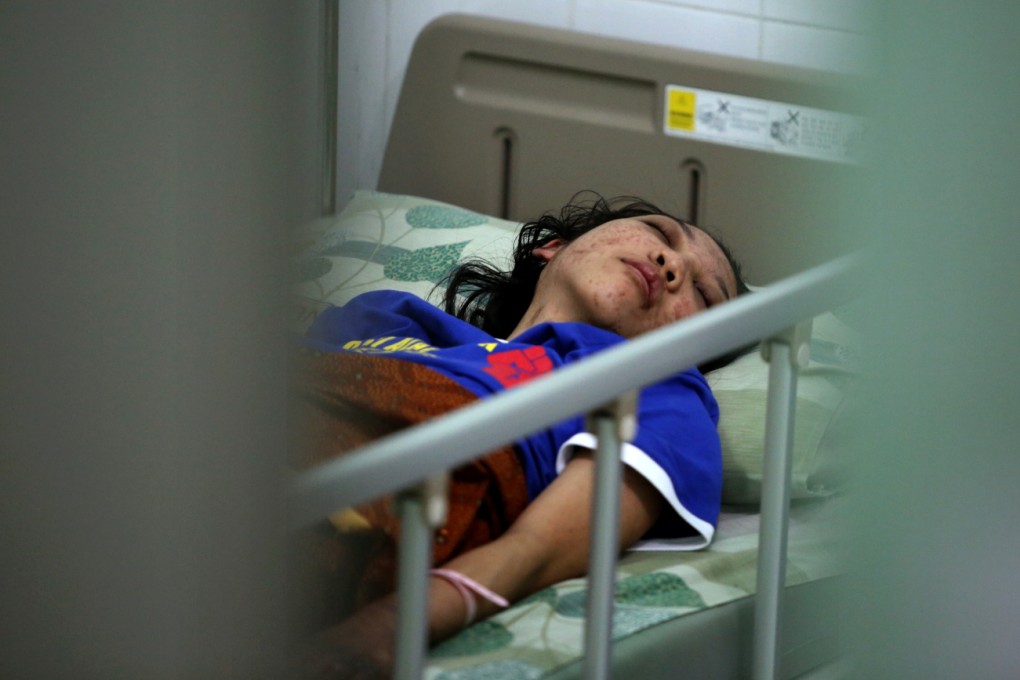 Indonesian domestic helper Erwiana Sulistyaningsih lies in a bed at a hospital in Central Java, Indonesia. Photo: Sam Tsang