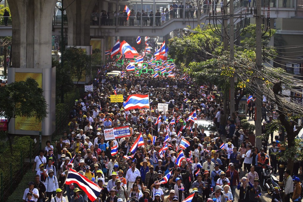 Thai anti-government protesters march on Sukhumvit Road, the main thoroughfare during the Bangkok Shutdown rally in Thailand. The capital is under a state of emergency and protests have taken a more violent turn with at least nine people killed and more than 500 injured. Photo: EPA