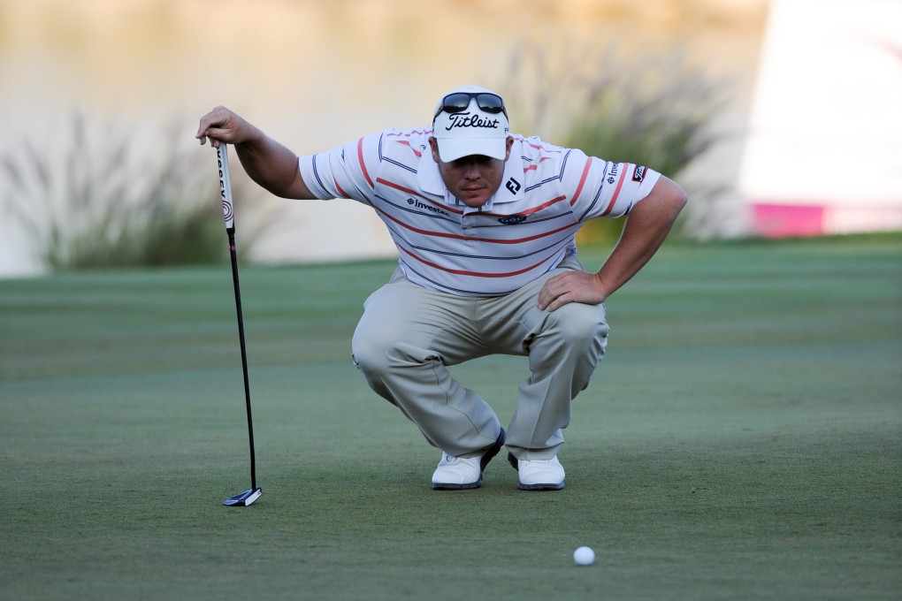 George Coetzee lines up a putt in the opening round of the  Qatar Masters in Doha. Photo: Xinhua