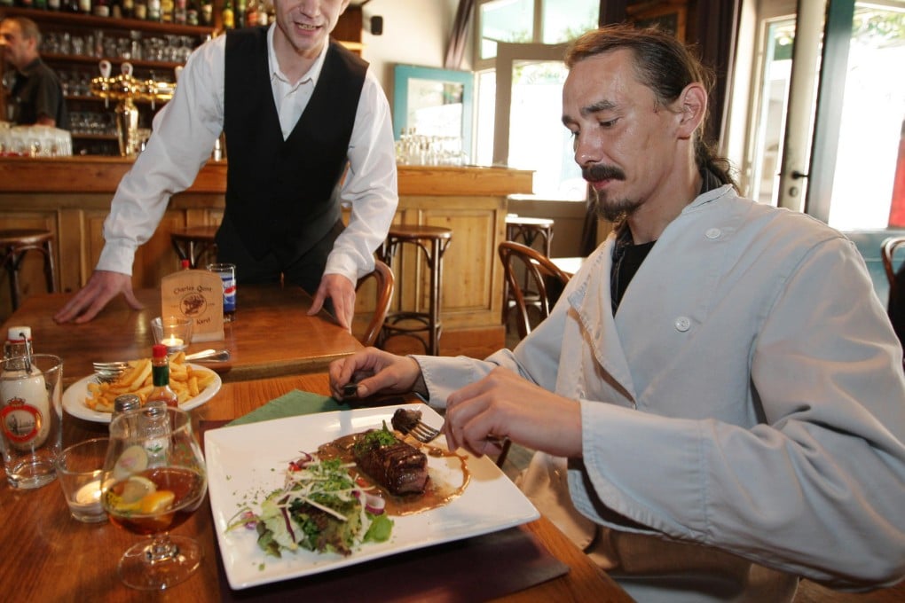 Titus Clarysse dining in 2009 in Ghent, Belgium. Notorious for not paying his bills, he was found dead in his home on Tuesday. Photo: AP