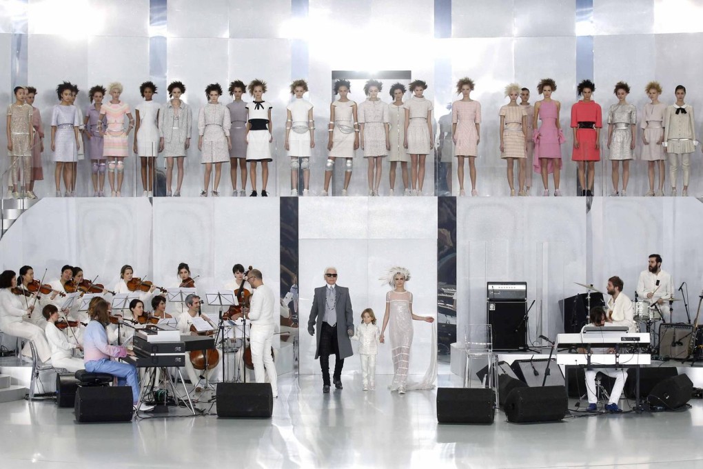 Karl Lagerfeld appears with models at the end of the Chanel haute couture show. Photos: Reuters, EPA, AFP