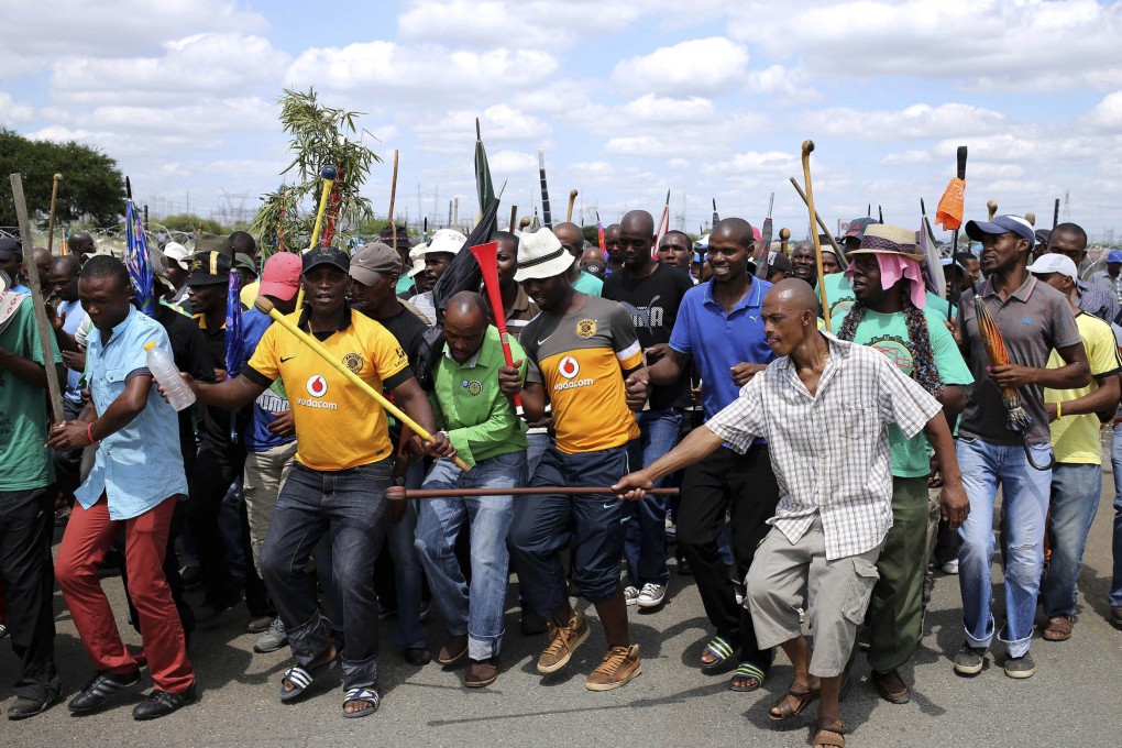 Mine workers protest outside the Lonmin plant in Rustenburg, South Africa. photo: Reuters