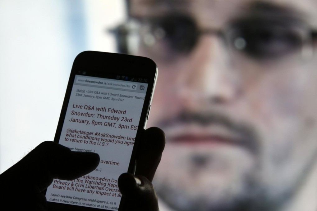 A man read updates from Edward Snowden during the ex-NSA contractor's online question-and-answer session. Photo: Reuters