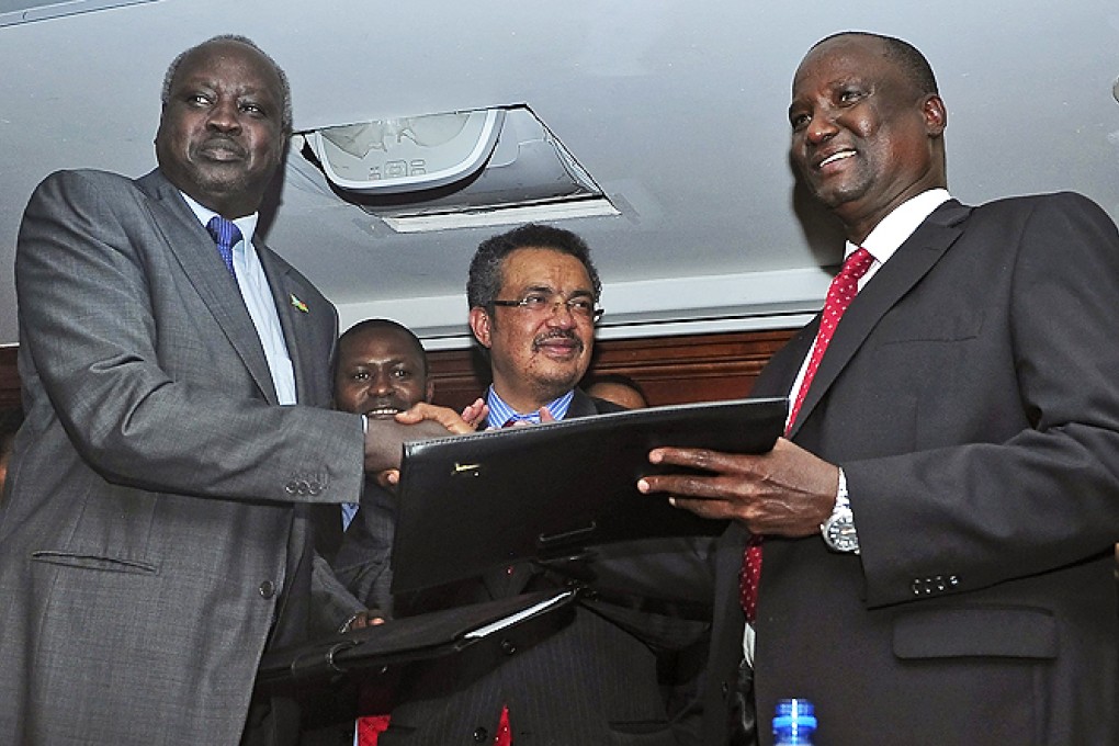 South Sudan's government-delegation leader Nhial Deng Nhial (left) and the rebel-delegation leader Taban Deng Gai (right) shake hands after signing a ceasefire agreement in Addis Ababa on Thursday. Photo: EPA