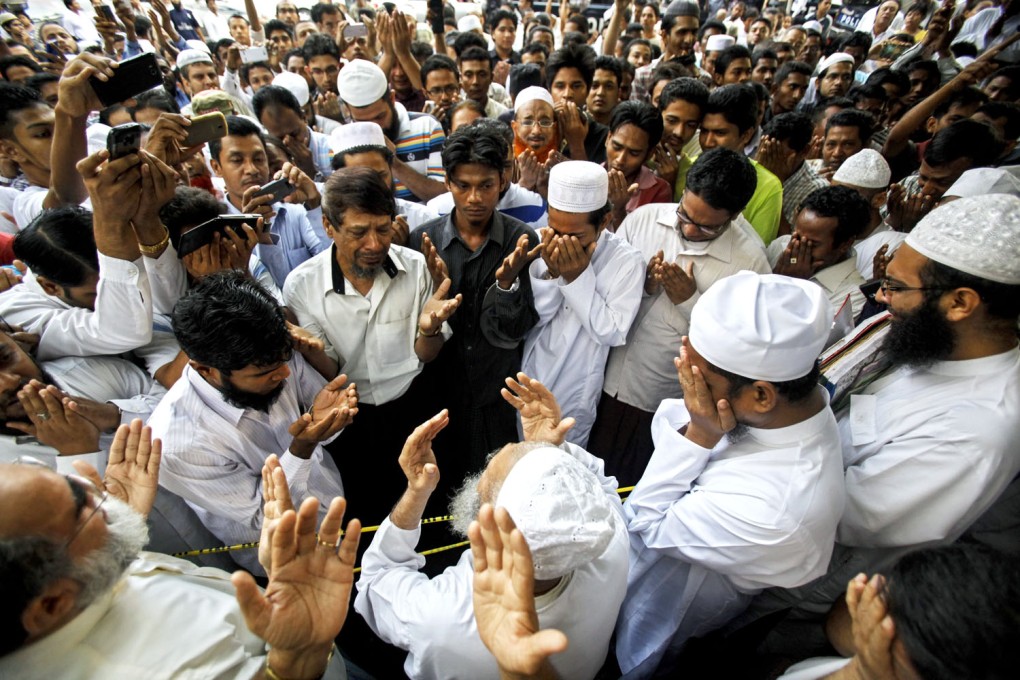 Muslim men in Yangon, Myanmar. UN says more than 40 Muslims were killed when a Buddhist mob stormed a village in western Myanmar last week.