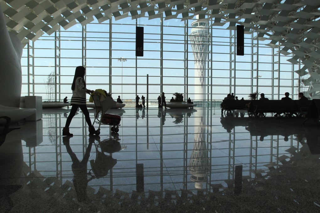 A woman pushes her baby through Shenzhen's Bao'an International Airport. Photo: K.Y. Cheng
