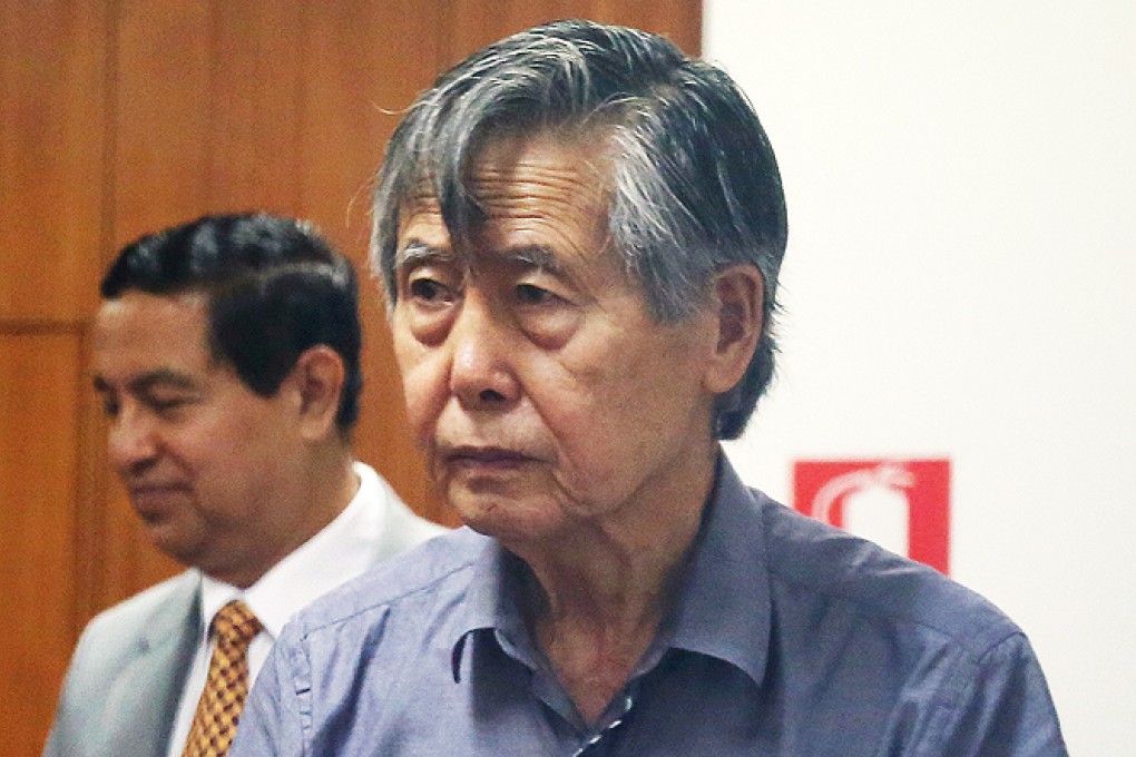 Jailed former President Alberto Fujimori enters the courtroom at a police base in Lima. Photo: AP
