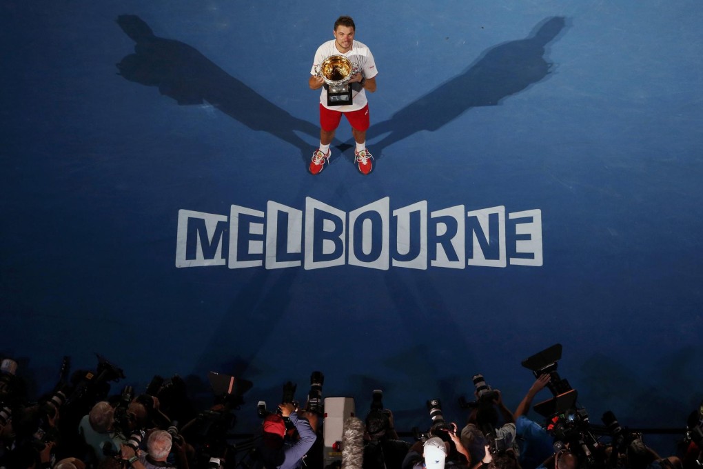 Stanislas Wawrinka, of Switzerland, poses with the Norman Brookes Challenge Cup after he scored a four-set victory over Spanish top seed Rafael Nadal in the men's singles final of the Australian Open on Sunday. Photo: Reuters