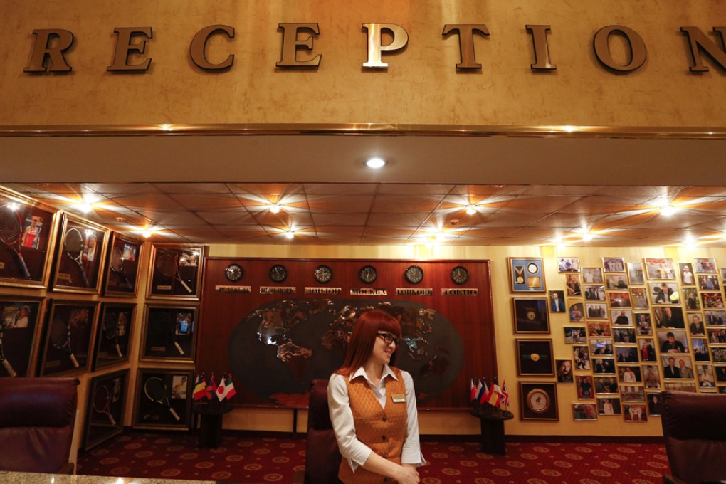 Receptionist waits for guests at Vesna hotel in the Adler district of Sochi. Photo: Reuters