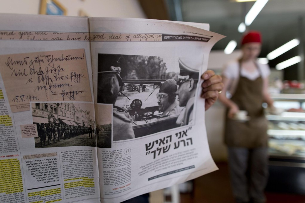 A man in an Israeli café reads a section devoted to the Himmler documents in the Israeli newspaperYedioth Ahronoth. Photo: EPA