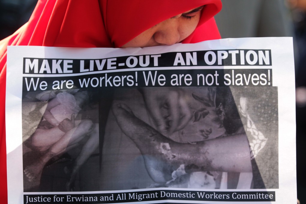 Demonstrators carry placards during a march in support of an Indonesian helper who was allegedly tortured by her employer in Hong Kong. Photo: Thomas Yau