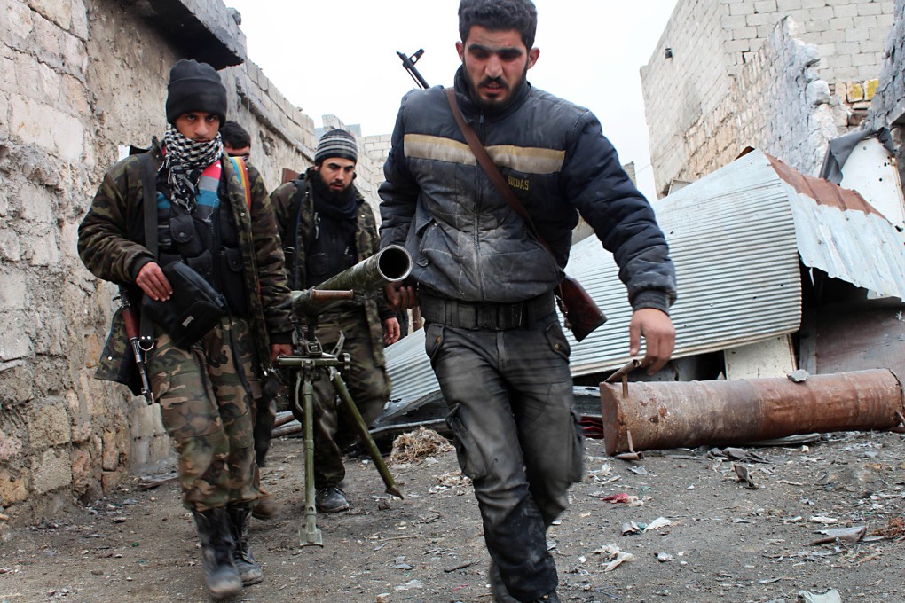 Opposition fighters carry a rocket launcher during clashes against government forces in the northern city of Aleppo. The US officials provided no indication about the status of lethal assistance such as body armor and ammunition. Photo: AFP