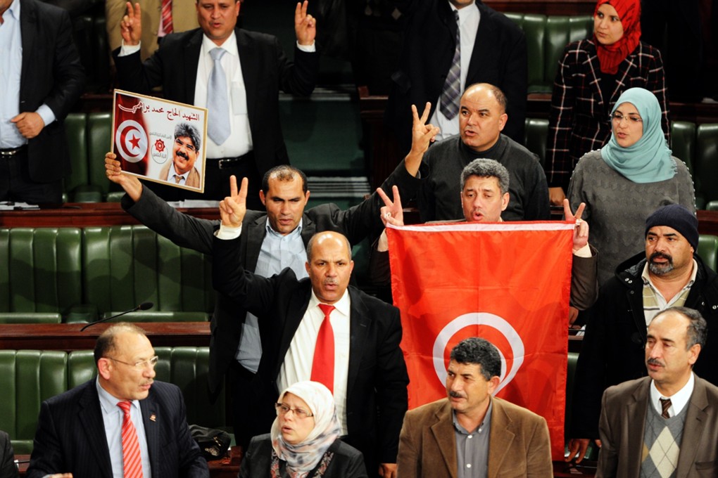 Members of the Tunisian National Constituent Assembly celebrate after the adoption of a new constitution on Sunday in Tunis. Photo: AFP