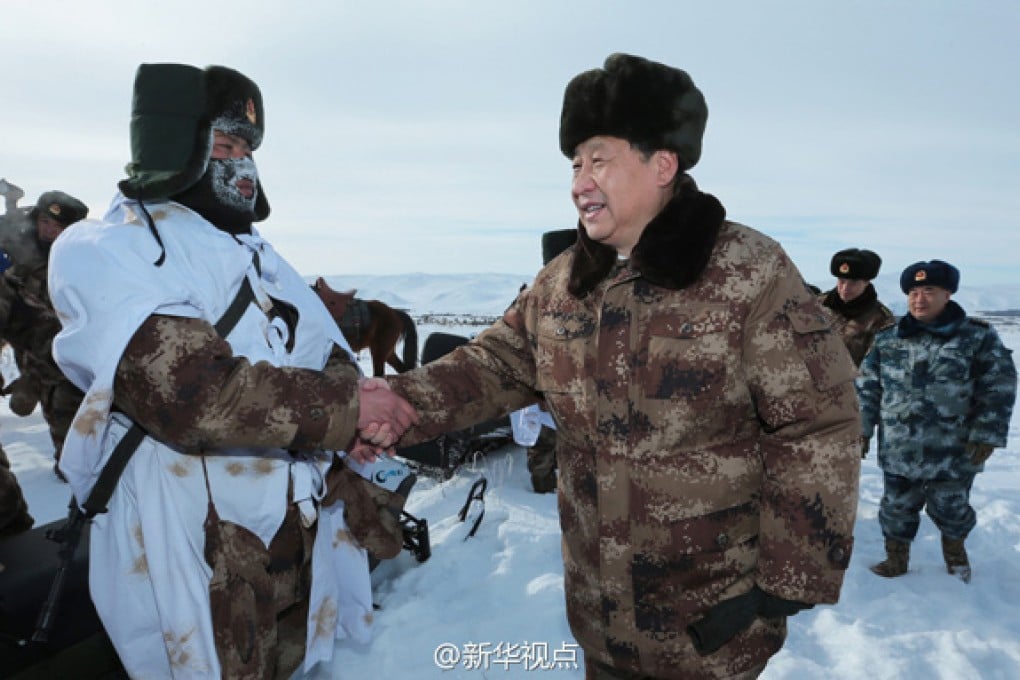 President Xi Jinping shakes hand with a border patrol soldier near Arxan, Inner Mongolia on January 26, 2014. Photo: Xinhua