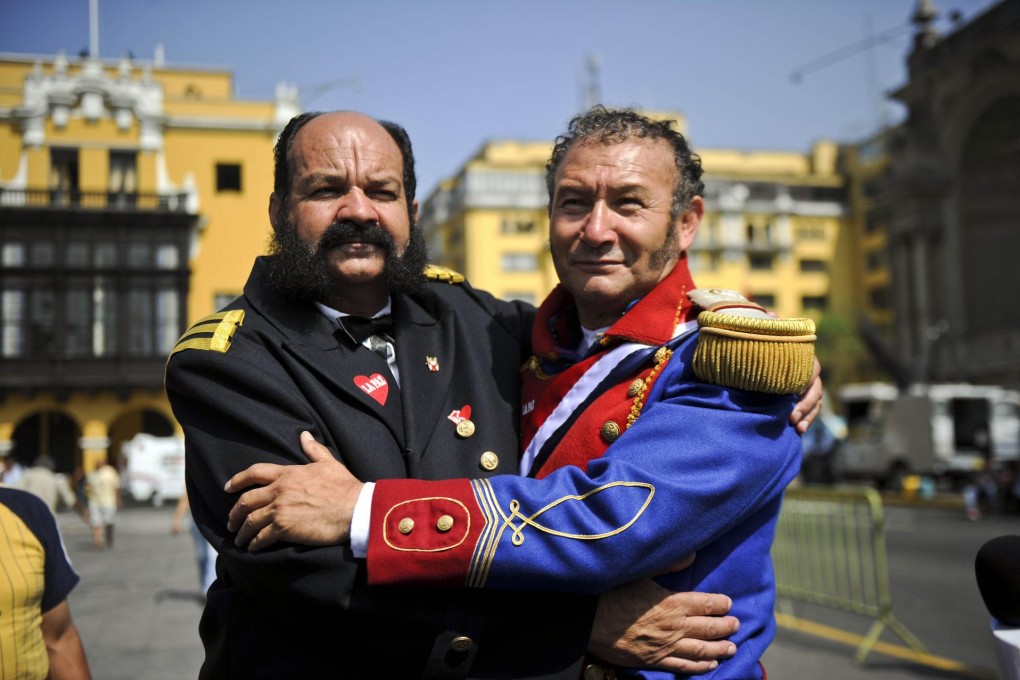 Protesters from Peru (left) and Chile in Lima. Photo: AFP