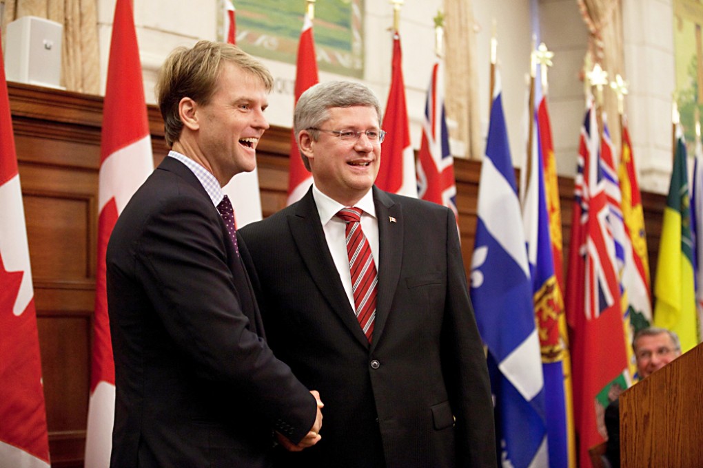 Canadian Immigration Minister Chris Alexander (left), pictured with Prime Minister Stephen Harper, wants migrants to live in Canada longer before qualifying for citizenship. Photo: SCMP
