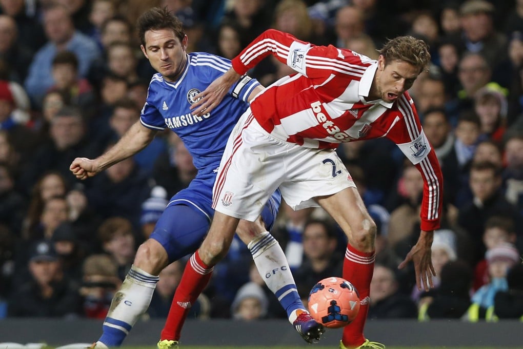 Chelsea's Frank Lampard (left) competes with Stoke City's Peter Crouch in their English FA Cup clash. Lampard say their victory  gave the Blues a confidence boost. Photo: AP
