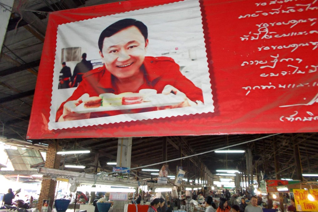 A market in Thaksin Shinawatra's hometown of San Kamphaeng, near Chiang Mai, displays a photograph of him. Photo: Tom Fawthrop