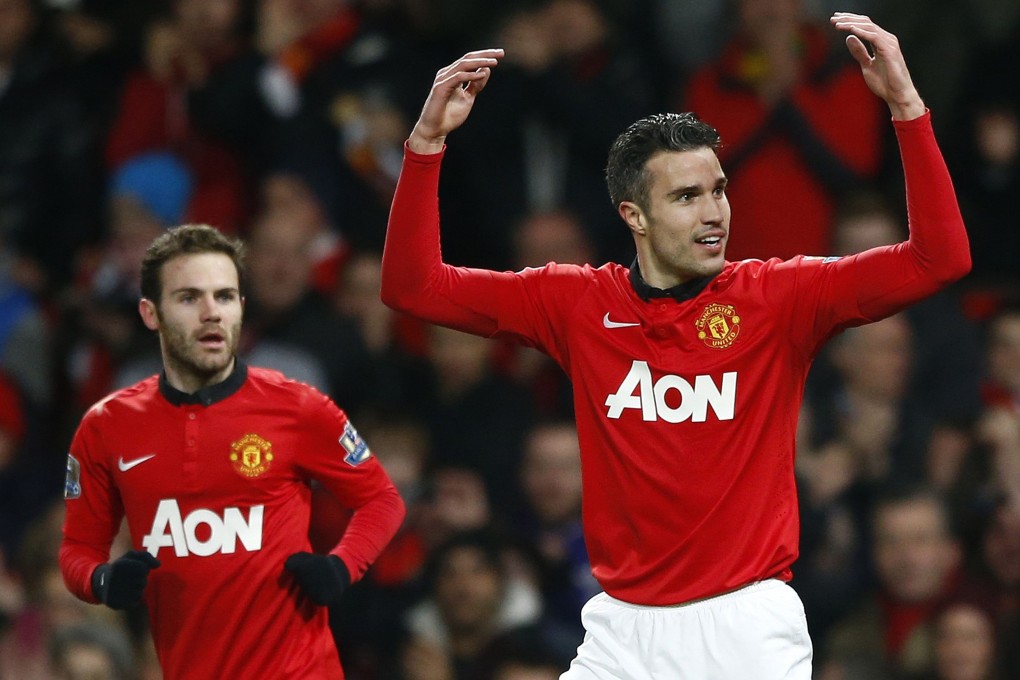 Manchester United's Juan Mata looks on as teammate Robin van Persie celebrates his goal against Cardiff City. Photo: Reuters