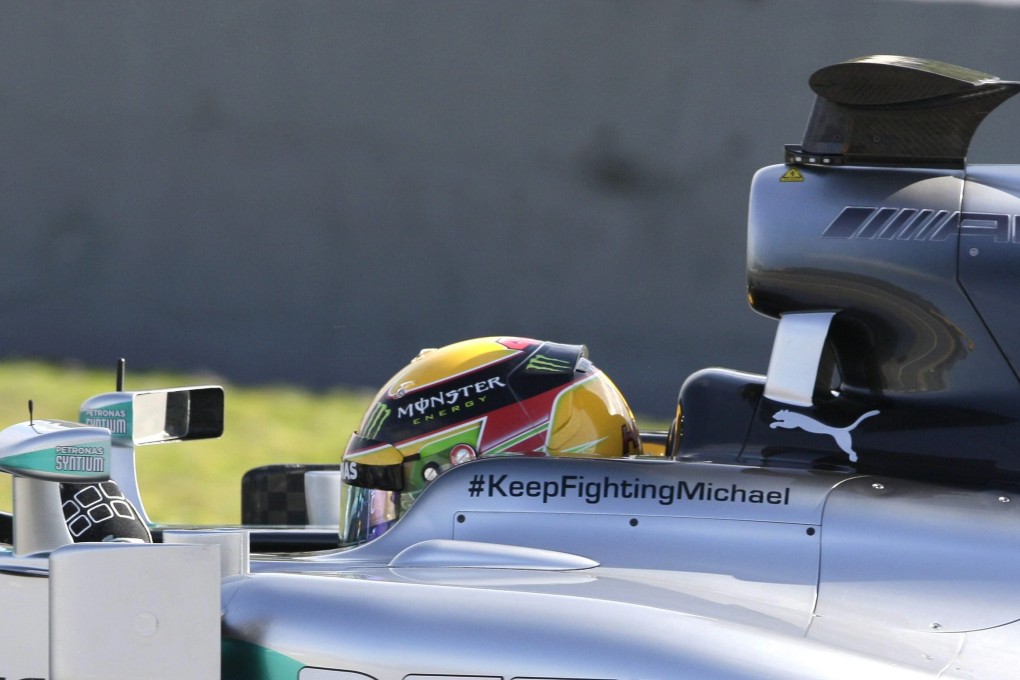 Lewis Hamilton's helmet bears a message of support for Michael Schumacher: #KeepFightingMichael. Photo: EPA
