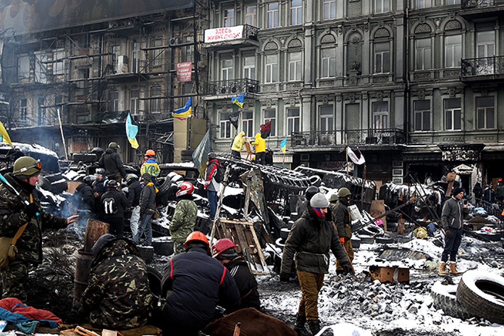Protesters gather at barricades during continuous anti-government protests in Kiev on Wednesday. Photo: EPA