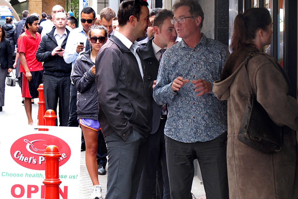 Workers queue at the Chef's Palette restaurant in Wellington on Tuesday. Photo: AP