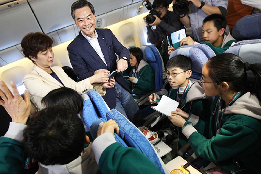 Chief Executive Leung Chun-ying and over a hundred residents from less privileged and single parent families join Cathay Pacific Spirit of Hong Kong Community Flight 2014 and spend 90 minutes on a journey over Hong Kong. Photo: Nora Tam