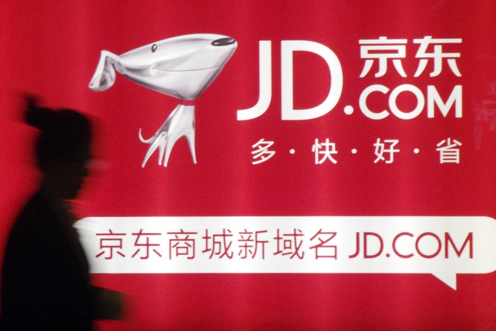 A woman walks past an advert for JD.com at Jingdong Mall in Nanjing. Photo: Reuters