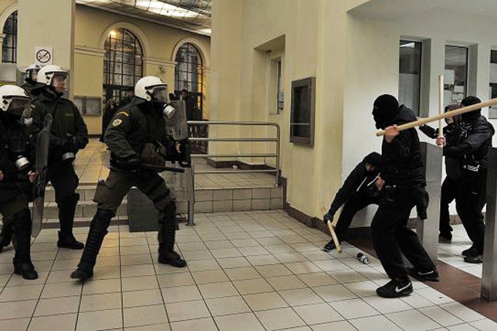 Riot police clash with anti-fascist demonstrators who gathered to oppose a Golden Dawn rally on Saturday. Photo: AFP