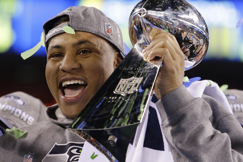 Seahawks' Malcolm Smith holds the Vince Lombardi Trophy after his team's Super Bowl success. Photo: AP